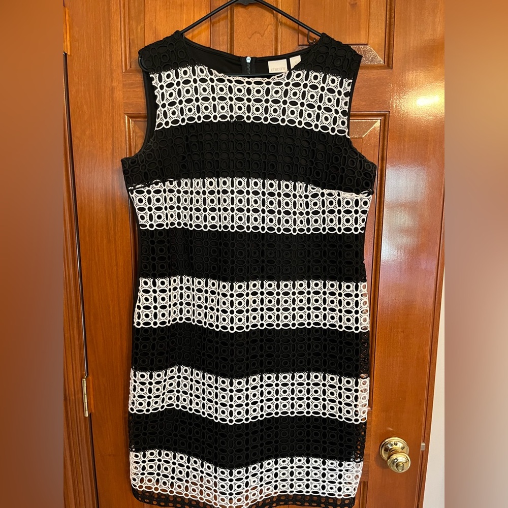 Black and white eyelet lace over ponte material. Sleeveless dress.